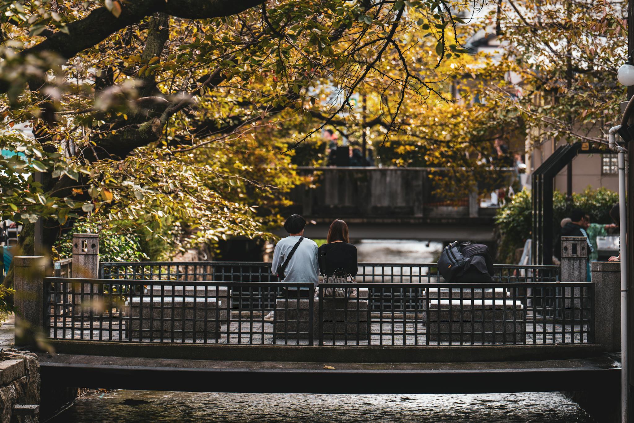 a couple relaxes on a serene bridge