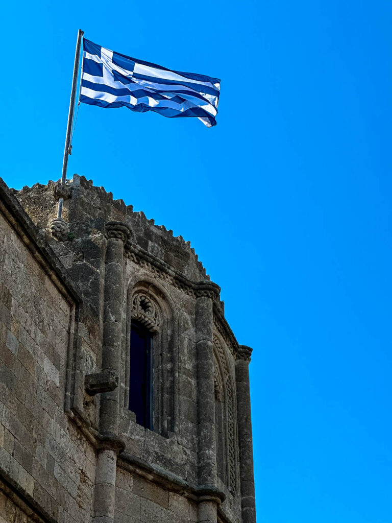 The Greek flag flies proudly atop the Old City (Rhodes, Greece)