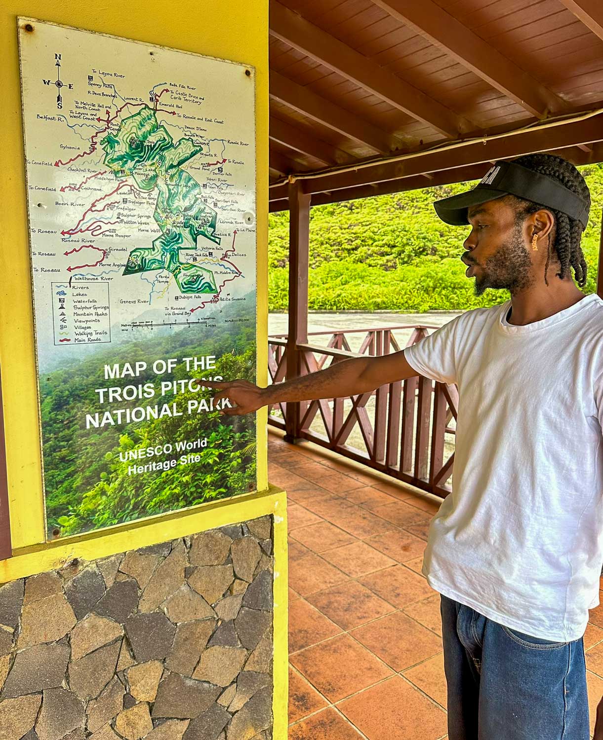 Local tour guide in Dominica assisting visitors exploring Morne Trois Pitons National Park
