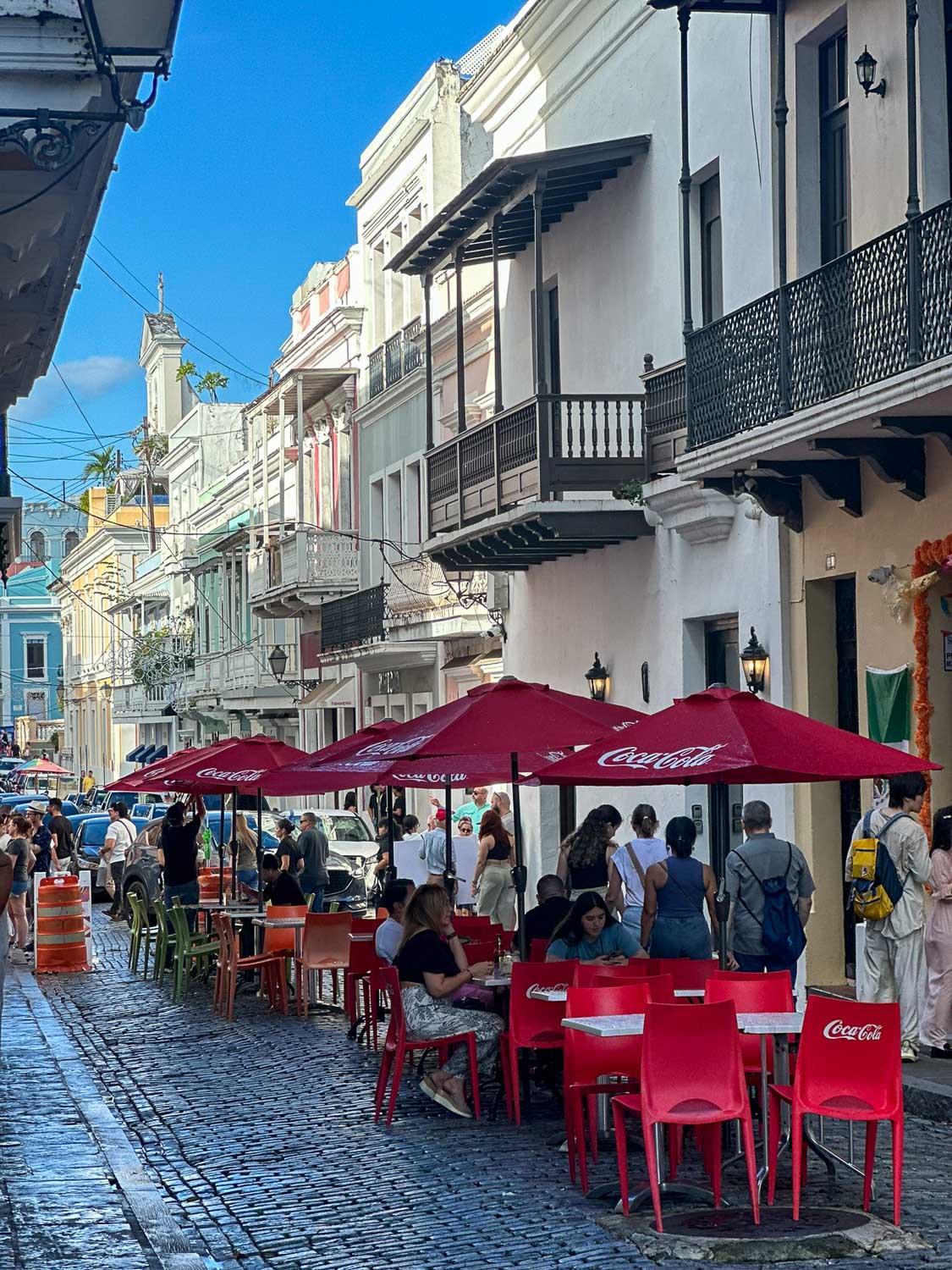 Café storefronts and outdoor seating along a street in Old San Juan (Puerto Rico)