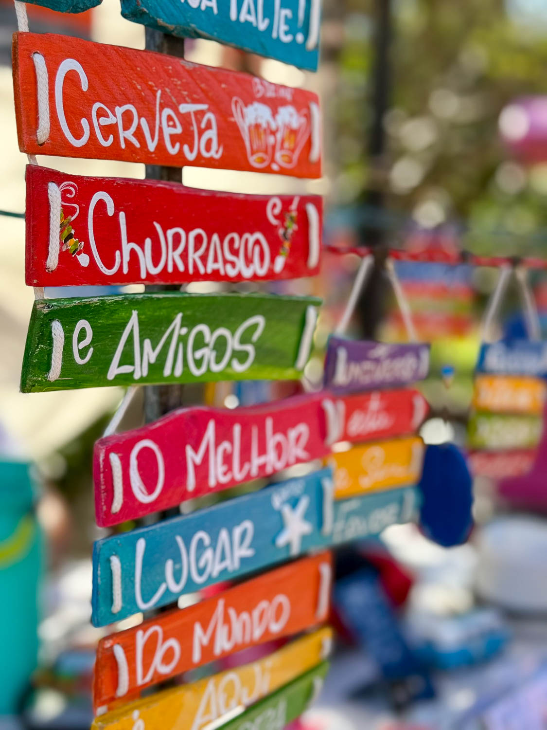 Buzios, Brazil Travel Guide: Best Things To See and Do 24 Hand-painted wooden signs at a local market in Buzios, Brazil
