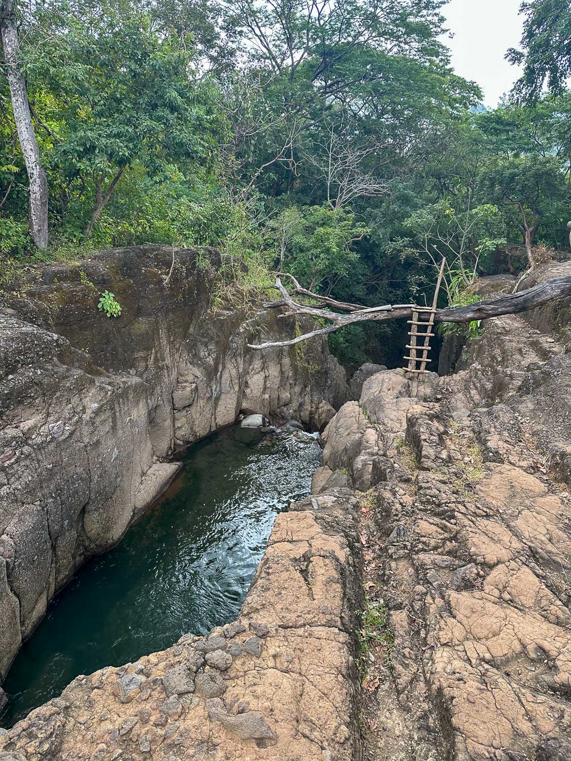 Cliff jumping into natural pools at Tamanique Waterfalls in El Salvador