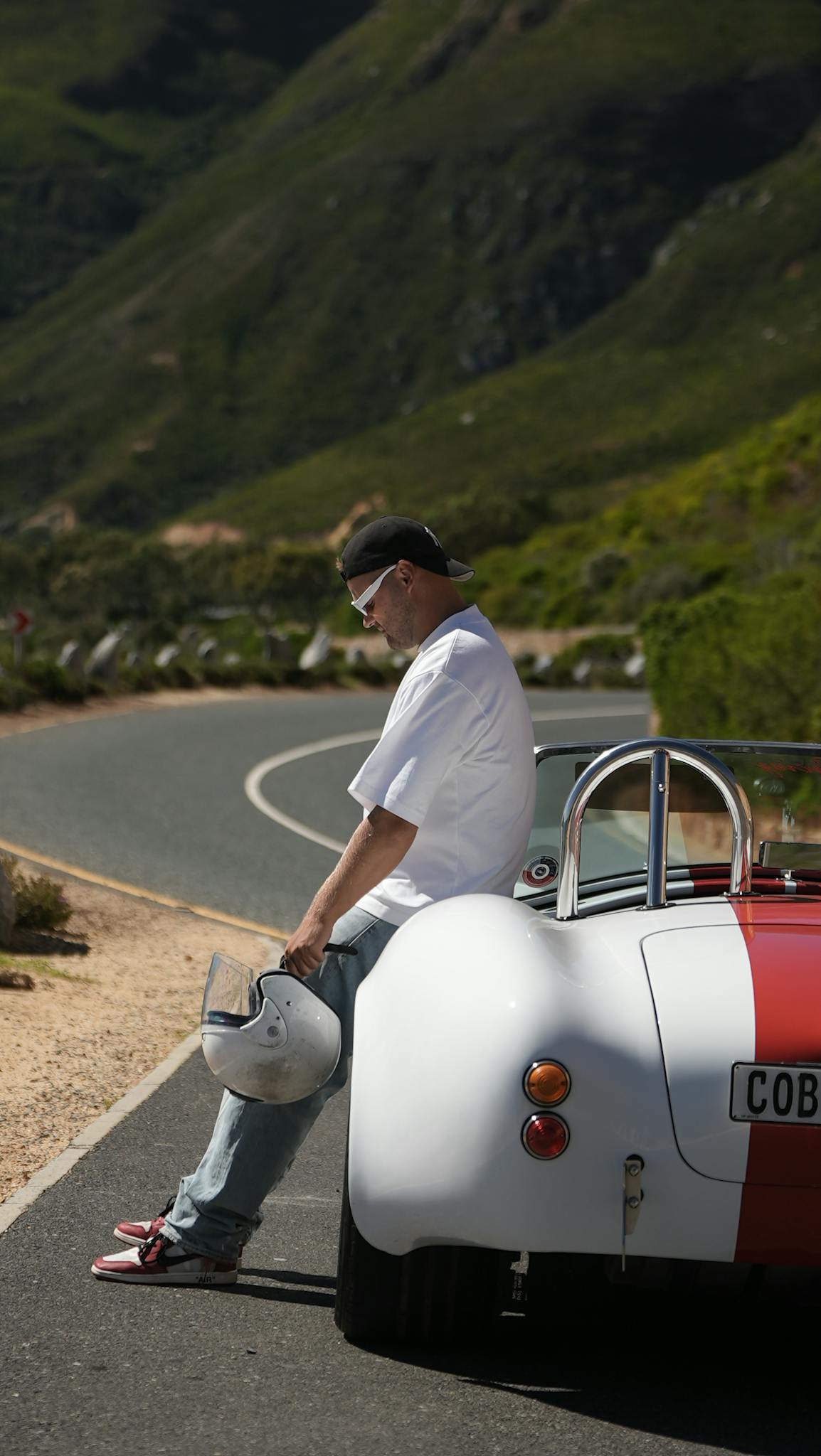 man sitting on a classic red and