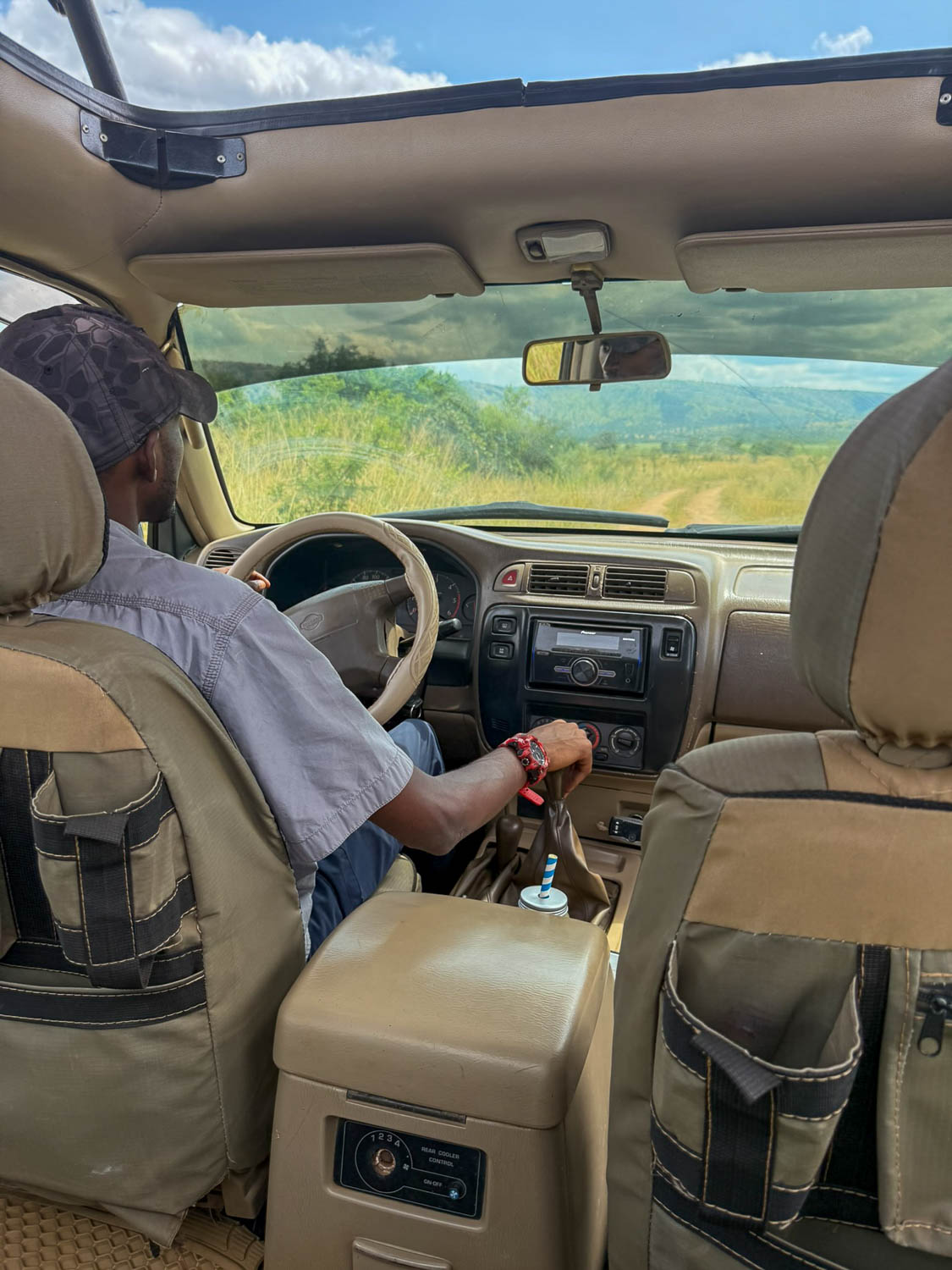 Safari guide assisting visitors during a wildlife experience in Akagera National Park, Rwanda