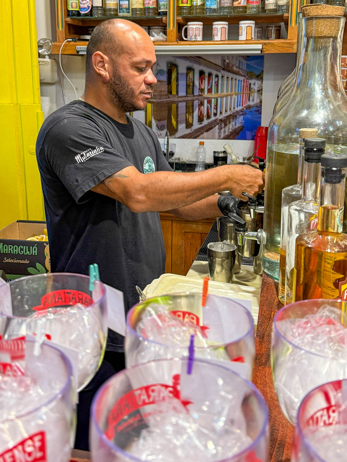 Bartender preparing a traditional Brazilian drink at Armazém da Cachaça in Paraty