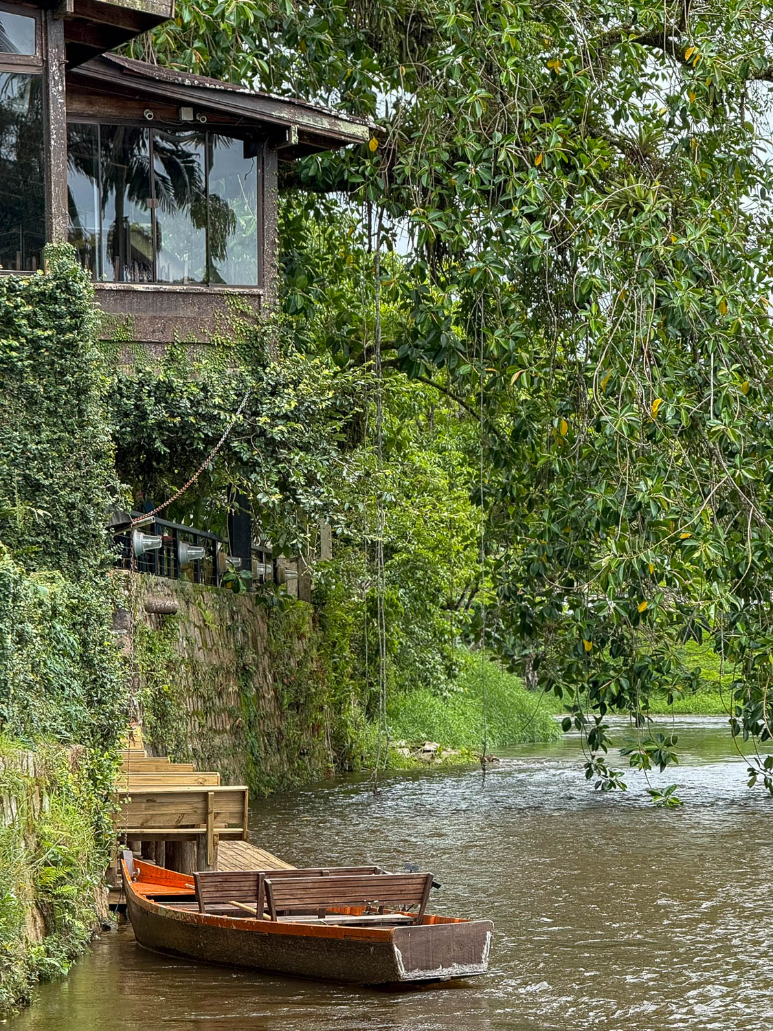 Small wooden boat on the Nhundiaquara River in Morretes, Paraná, offering scenic river tours through the historic town.