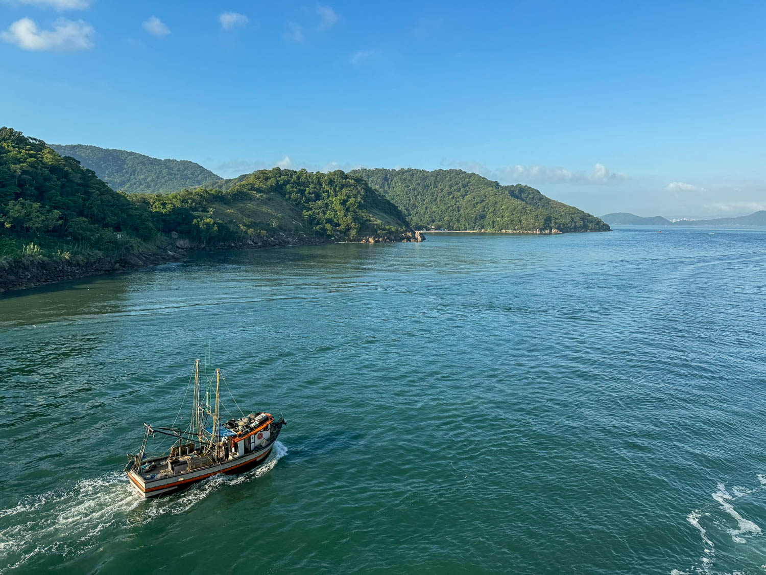 Boat tour departing from Santos, Brazil, offering views of the Atlantic coastline near the Port of Santos.