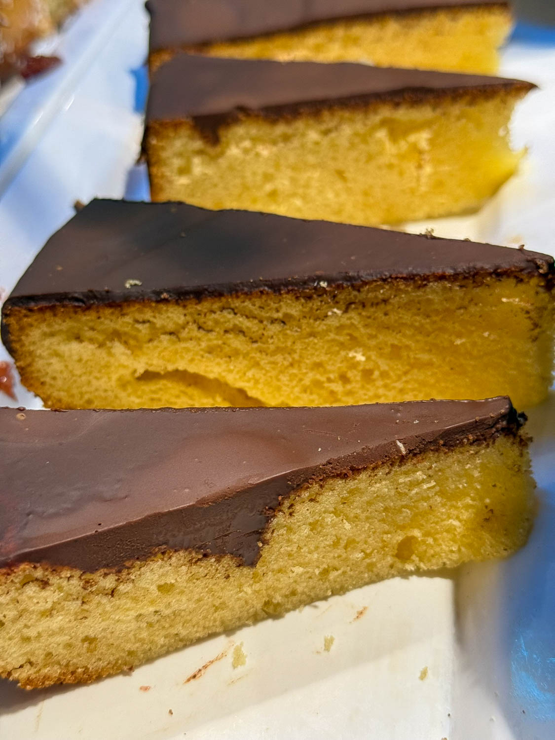 Traditional Brazilian Food: Iconic Dishes, Snacks, and Desserts 28 Brazilian bolo de cenoura carrot cake with chocolate glaze served with coffee