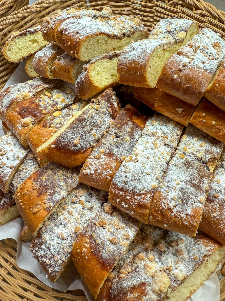 Traditional Brazilian food displayed in a neighborhood bakery featuring classic breads and pastries