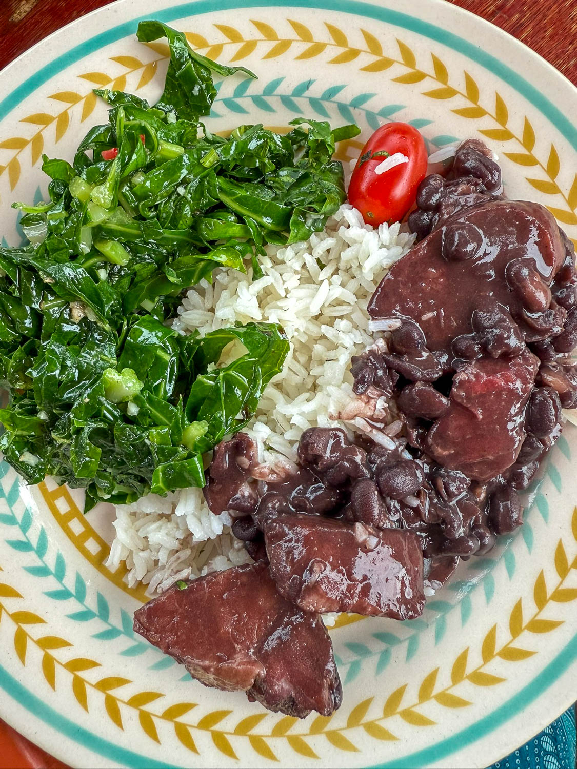 Traditional Brazilian Food: Iconic Dishes, Snacks, and Desserts 12 Feijoada served with rice, collard greens, and traditional Brazilian side dishes