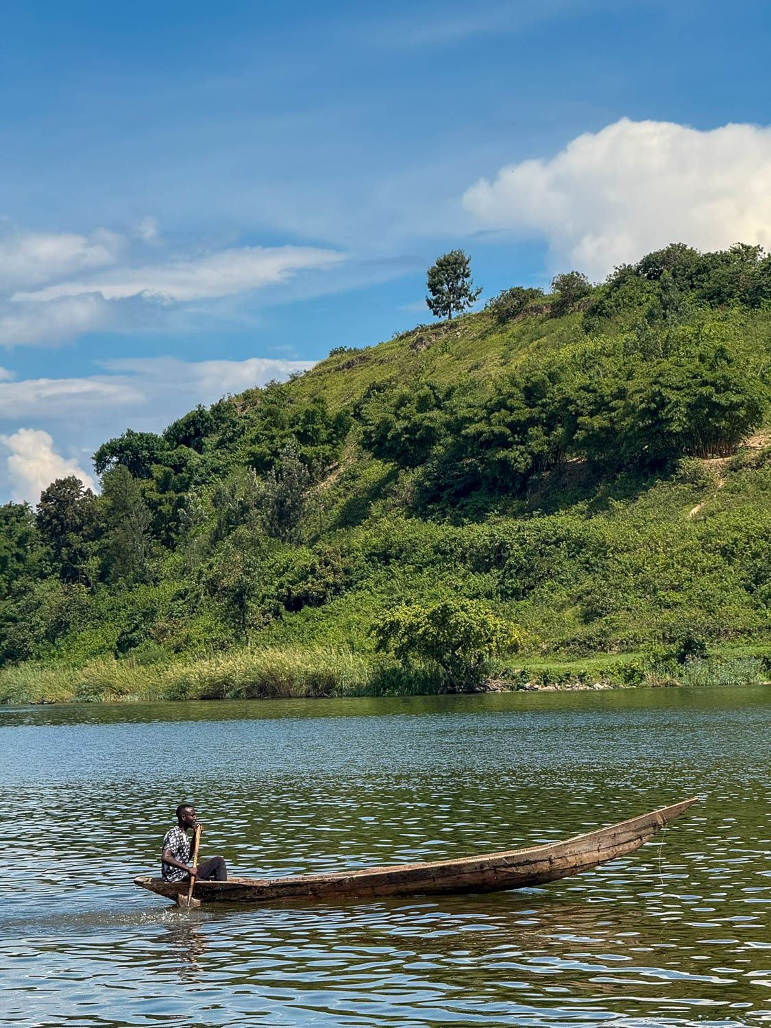 Local boatman heading out across Lake Kivu waters in Rwanda