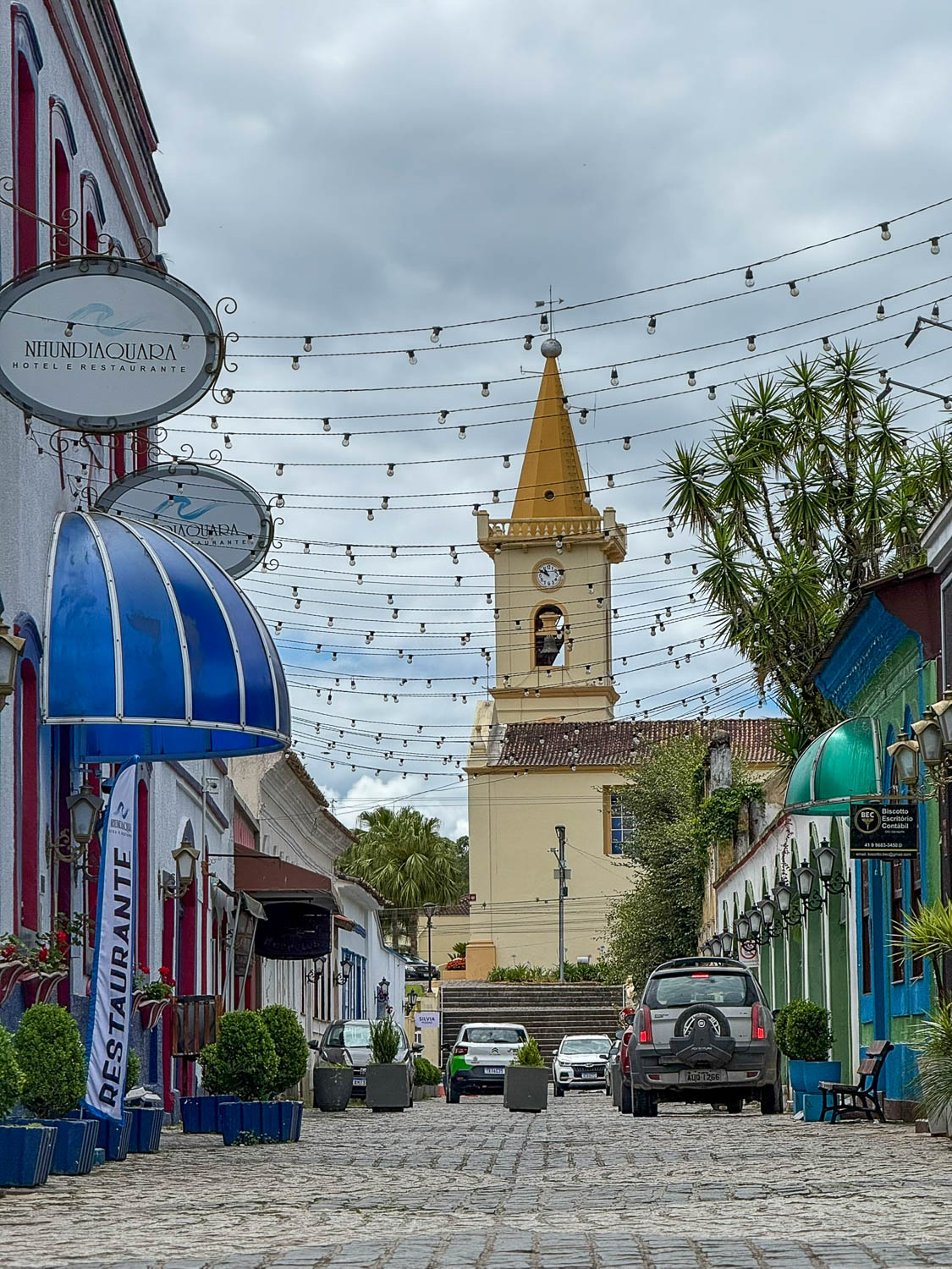 Cobblestone streets in the historic center of Morretes, Paraná, lined with colorful colonial buildings.