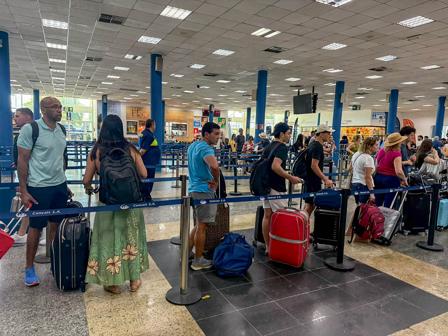 Cruise passengers waiting in embarkation lines at the Port of Santos cruise terminal in Brazil.