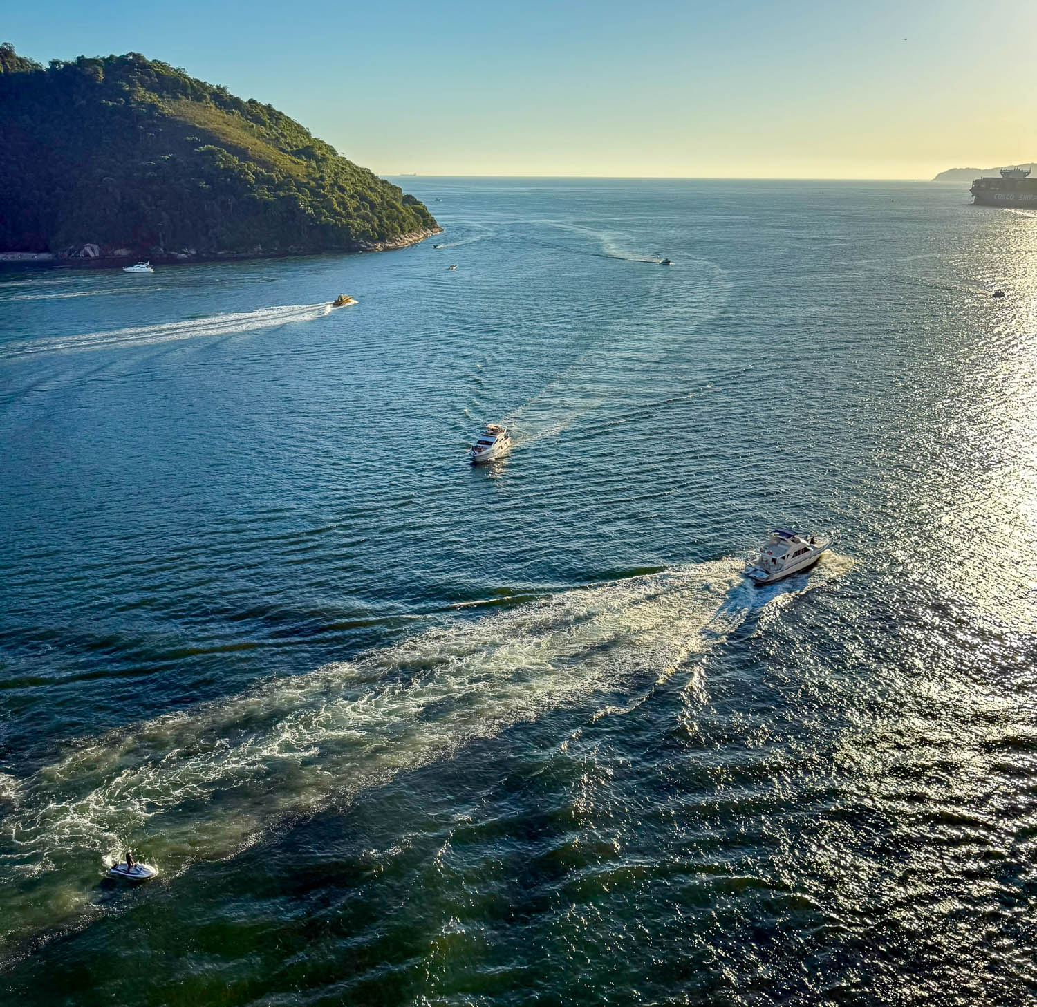 Cruise ship sailing away from the Port of Santos, Brazil, leaving the busy commercial port behind.