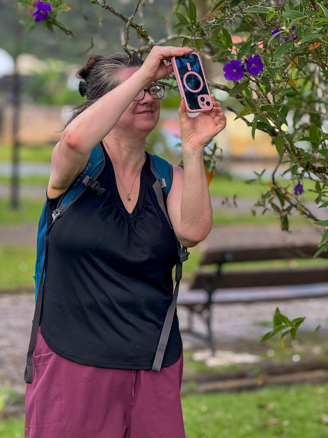 Traveler photographing wildlife in the Atlantic Forest near Morretes Paraná Brazil along the Serra Verde Express route