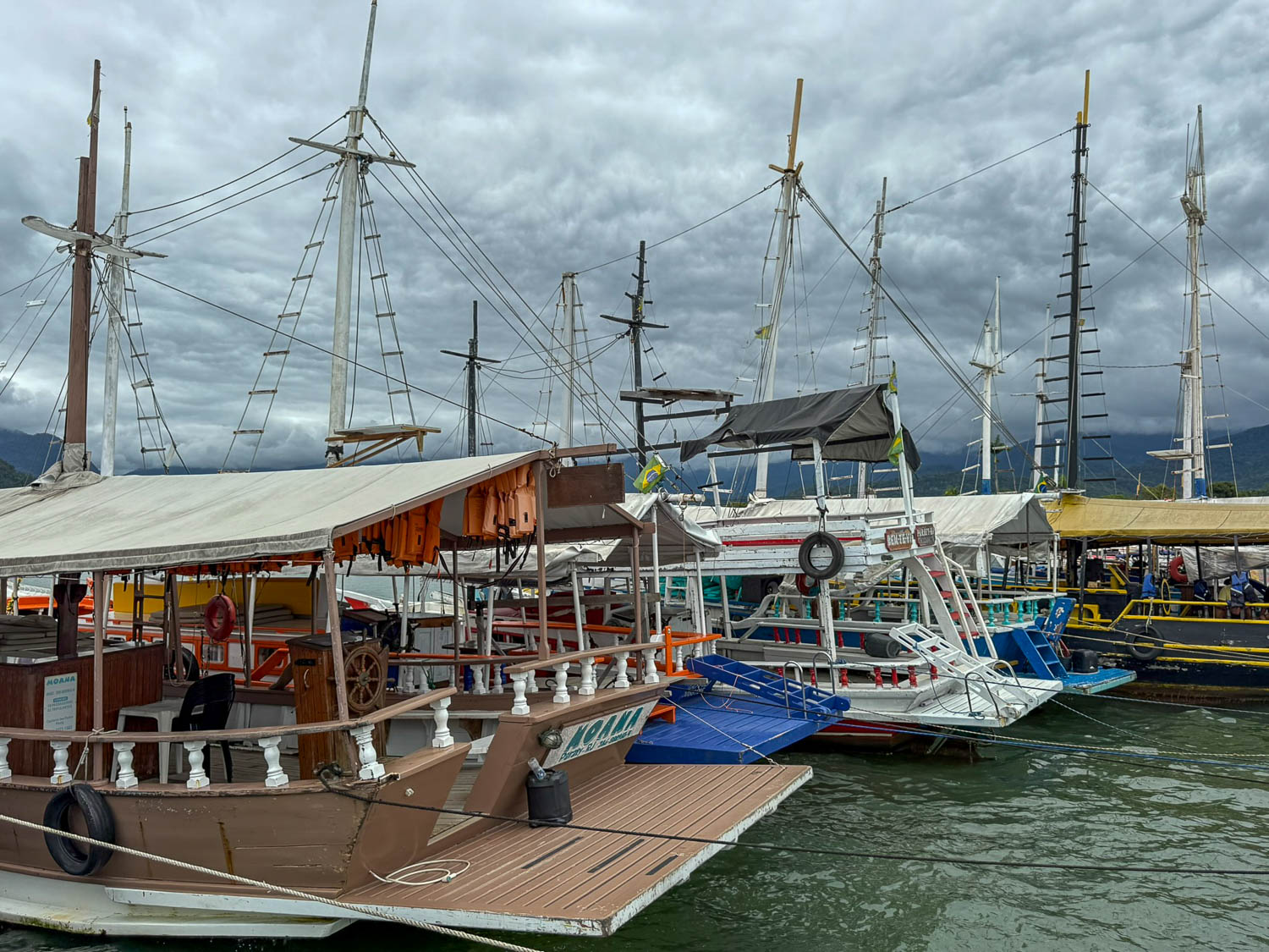 Colorful tour boats docked in Paraty Bay ready for island excursions in Brazil