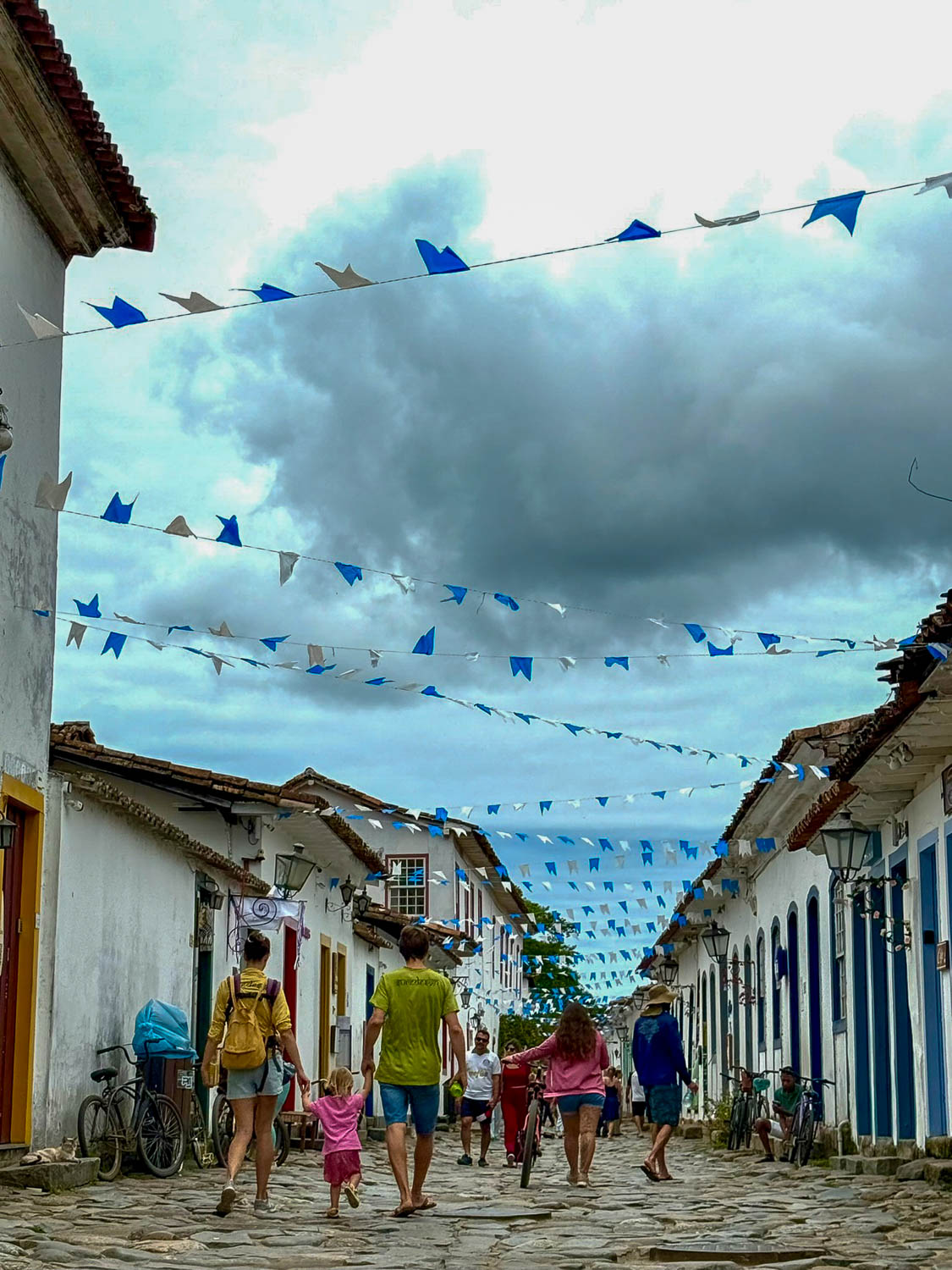 Visitors walking through pedestrian cobblestone streets in Paraty historic center, Brazil