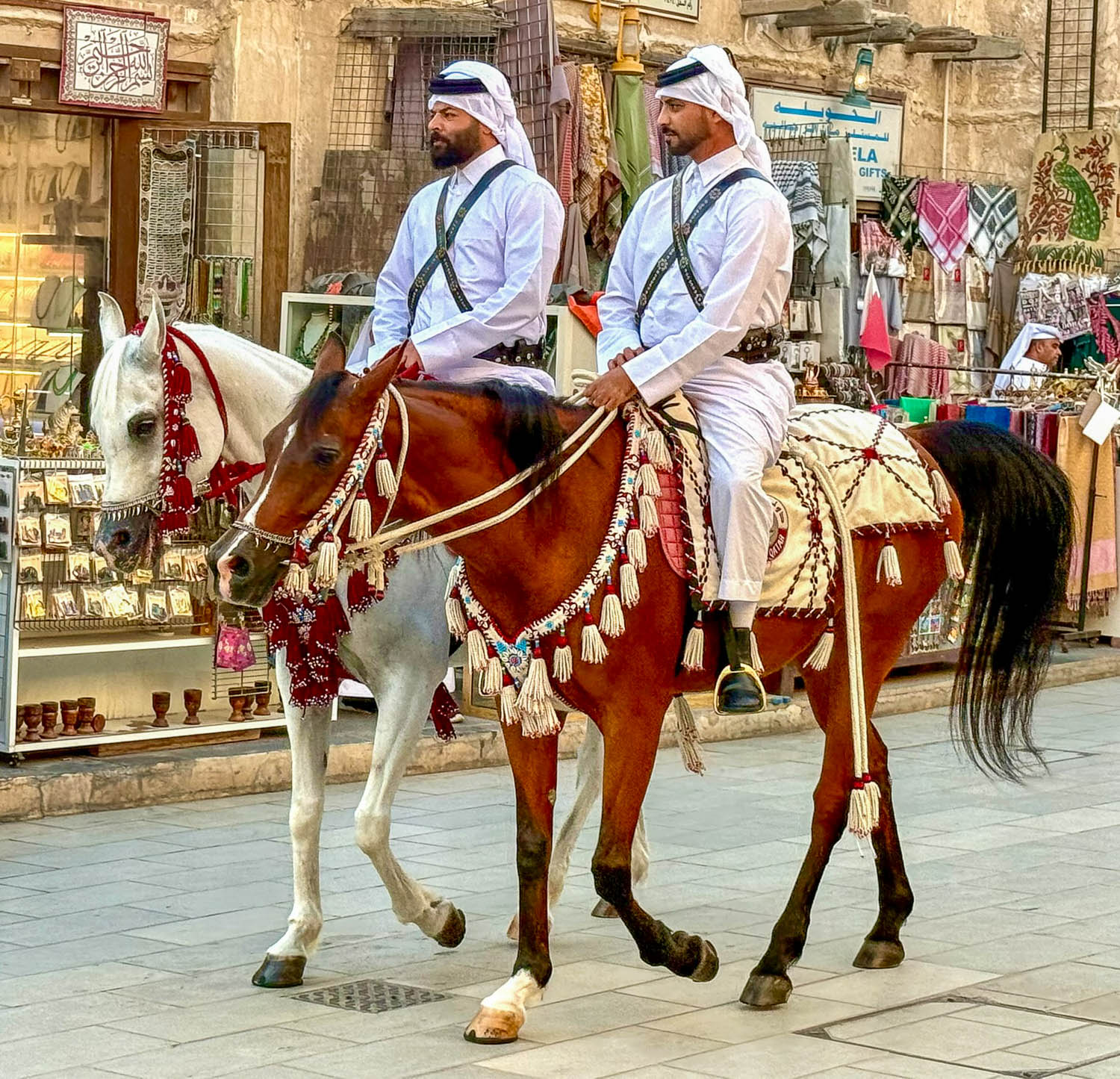 Arabian horses parading through Souq Waqif during evening festival in Doha Qatar