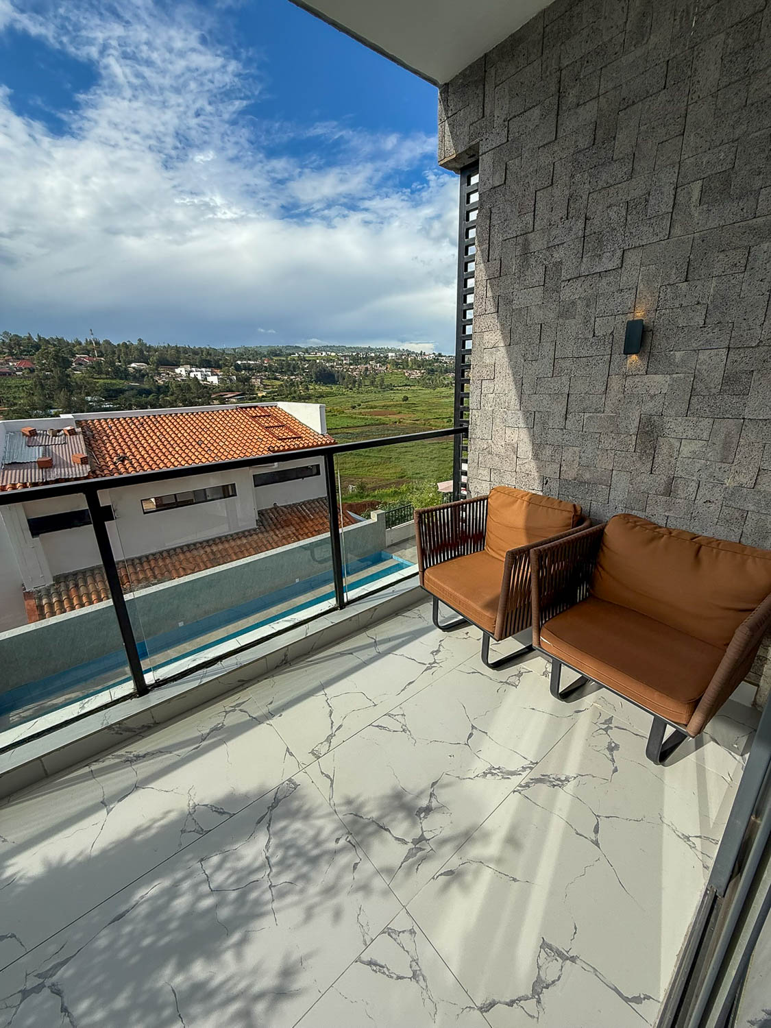 Kigali hotel accommodations with swimming pool and balcony views over the city