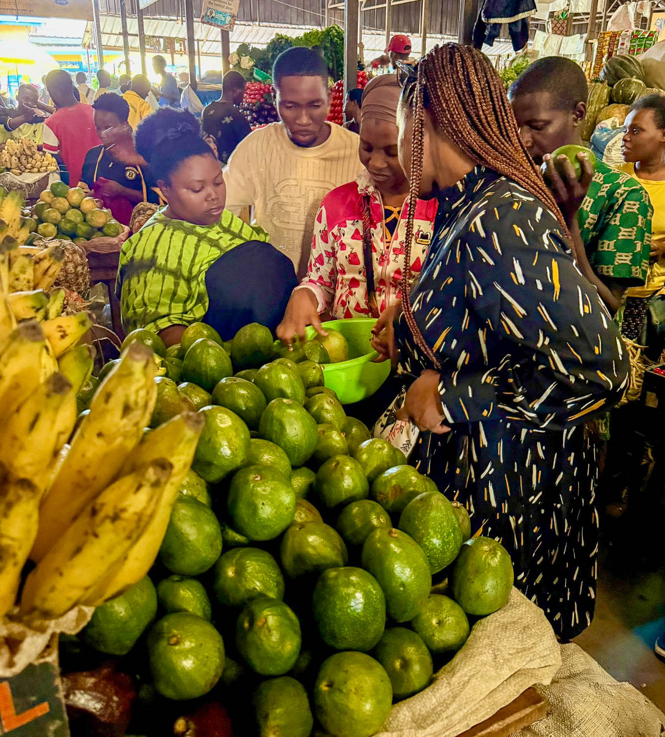 Fresh avocados for sale at Kimironko Market in Kigali, commonly used in Rwandan cuisine