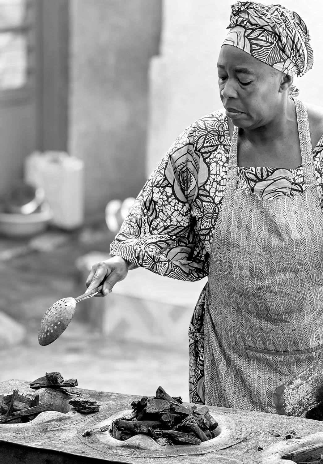 Traditional Rwandan cuisine being cooked over open coals at Nyamirambo Women’s Center in Kigali