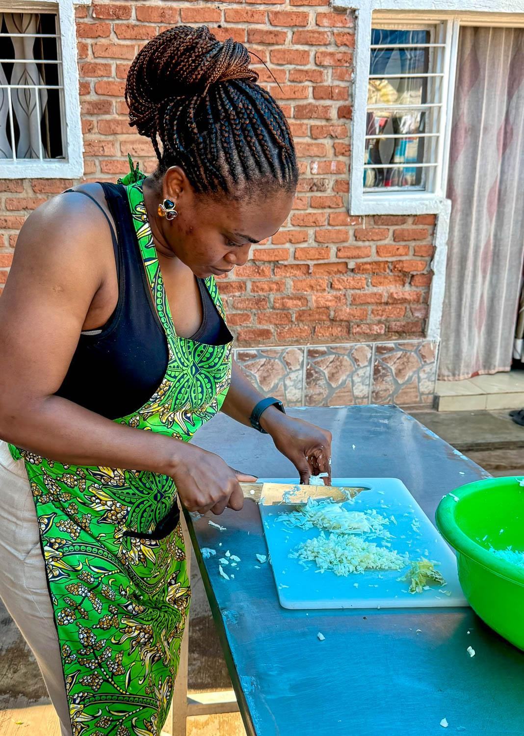 Preparing fresh ingredients for a traditional Rwandan cuisine meal in Kigali
