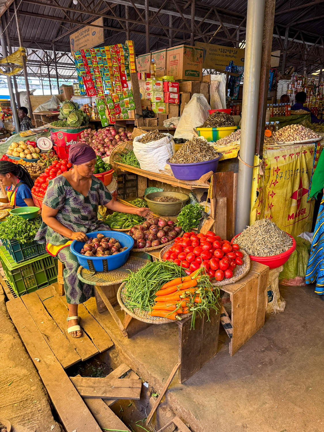 Local shoppers buying fresh ingredients at Kimironko Market in Kigali for Rwandan cuisine