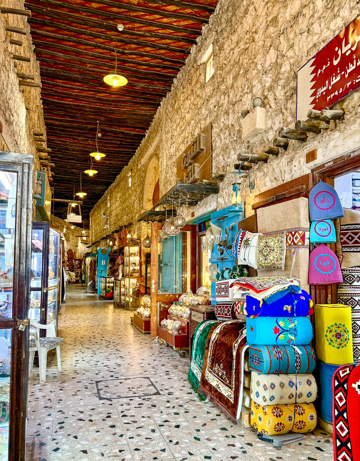 Narrow winding alleyways inside Souq Waqif Doha Qatar filled with shops and traditional market atmosphere
