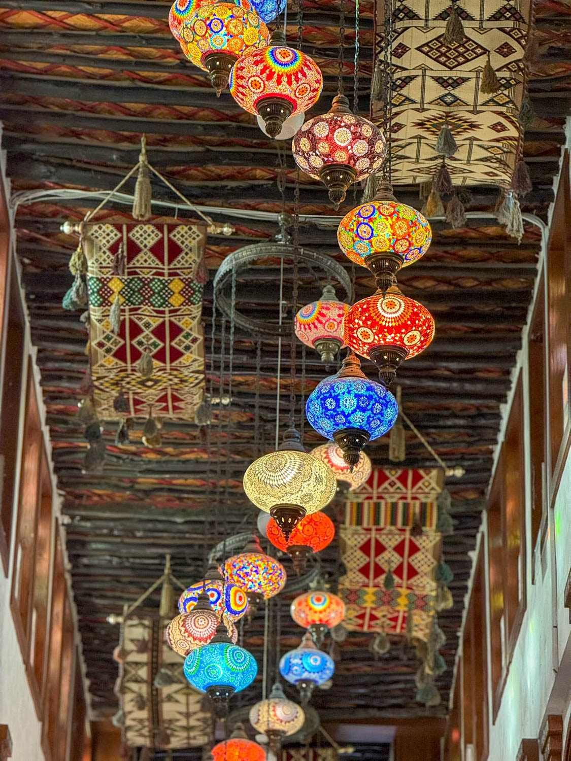 Colorful handmade lanterns inside Souq Waqif Art Center Doha Qatar highlighting traditional design
