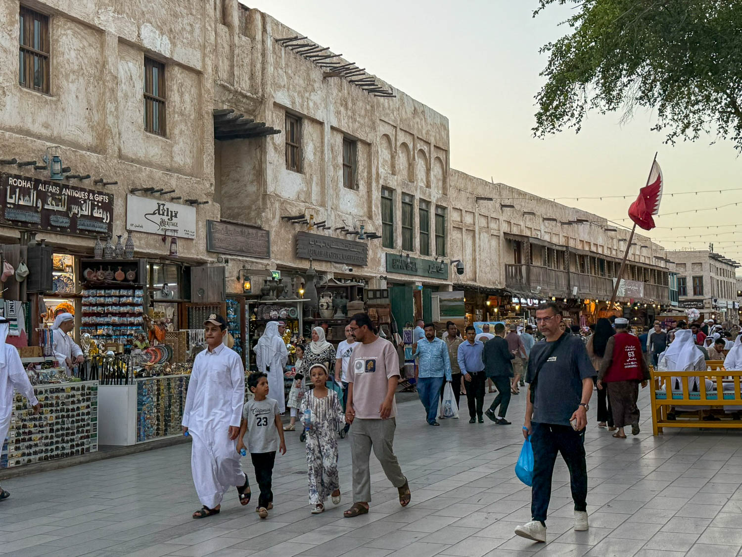 Busy evening crowds at Souq Waqif in Doha Qatar as visitors explore shops restaurants and cultural attractions