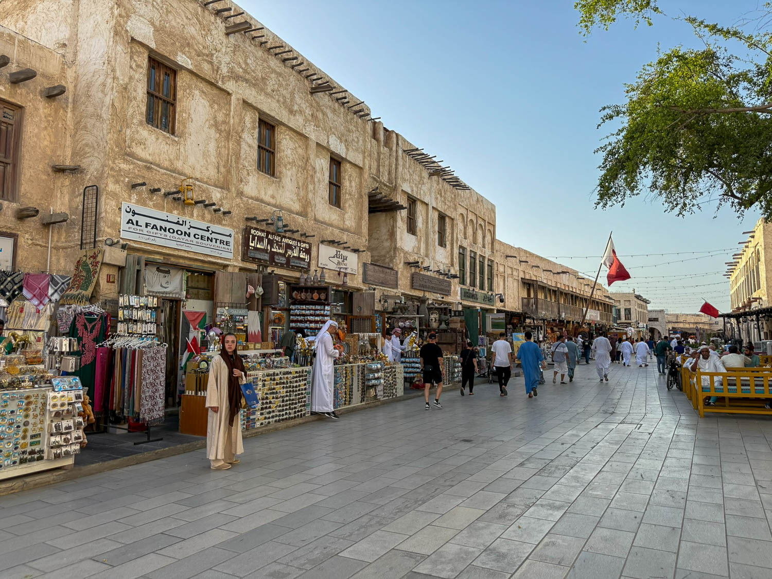 Main open walkway inside Souq Waqif Doha Qatar with visitors exploring the historic marketplace