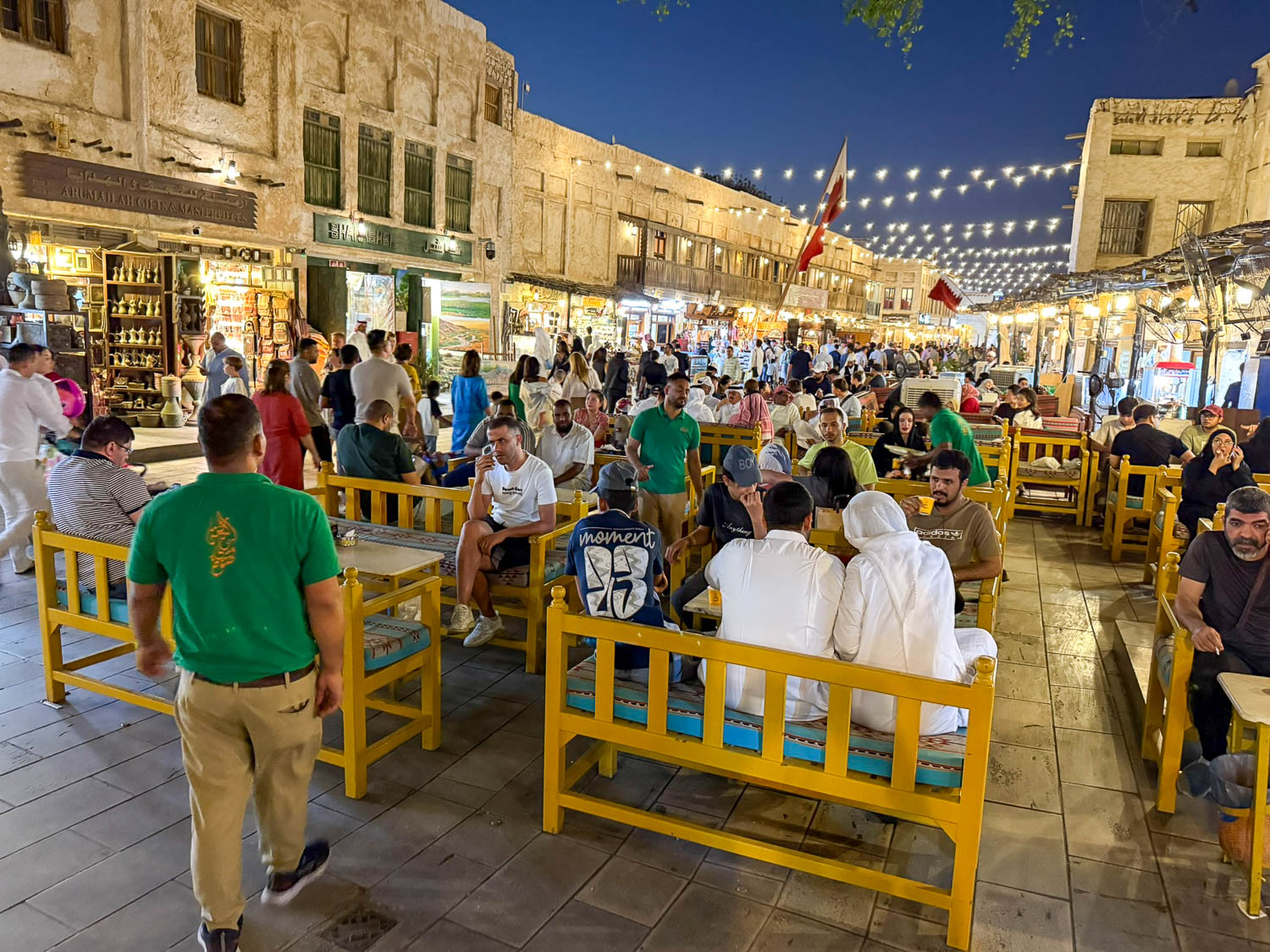 Nighttime crowds at Souq Waqif in Doha Qatar with busy walkways and vibrant evening atmosphere