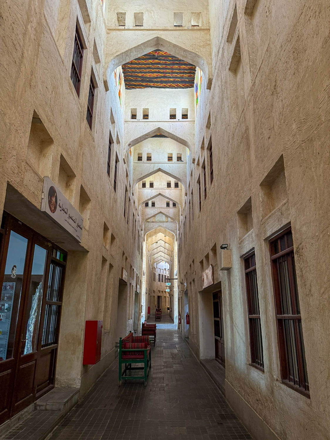 Quiet alleyway inside Souq Waqif near the Falcon Souq in Doha Qatar showing traditional architecture and peaceful market atmosphere
