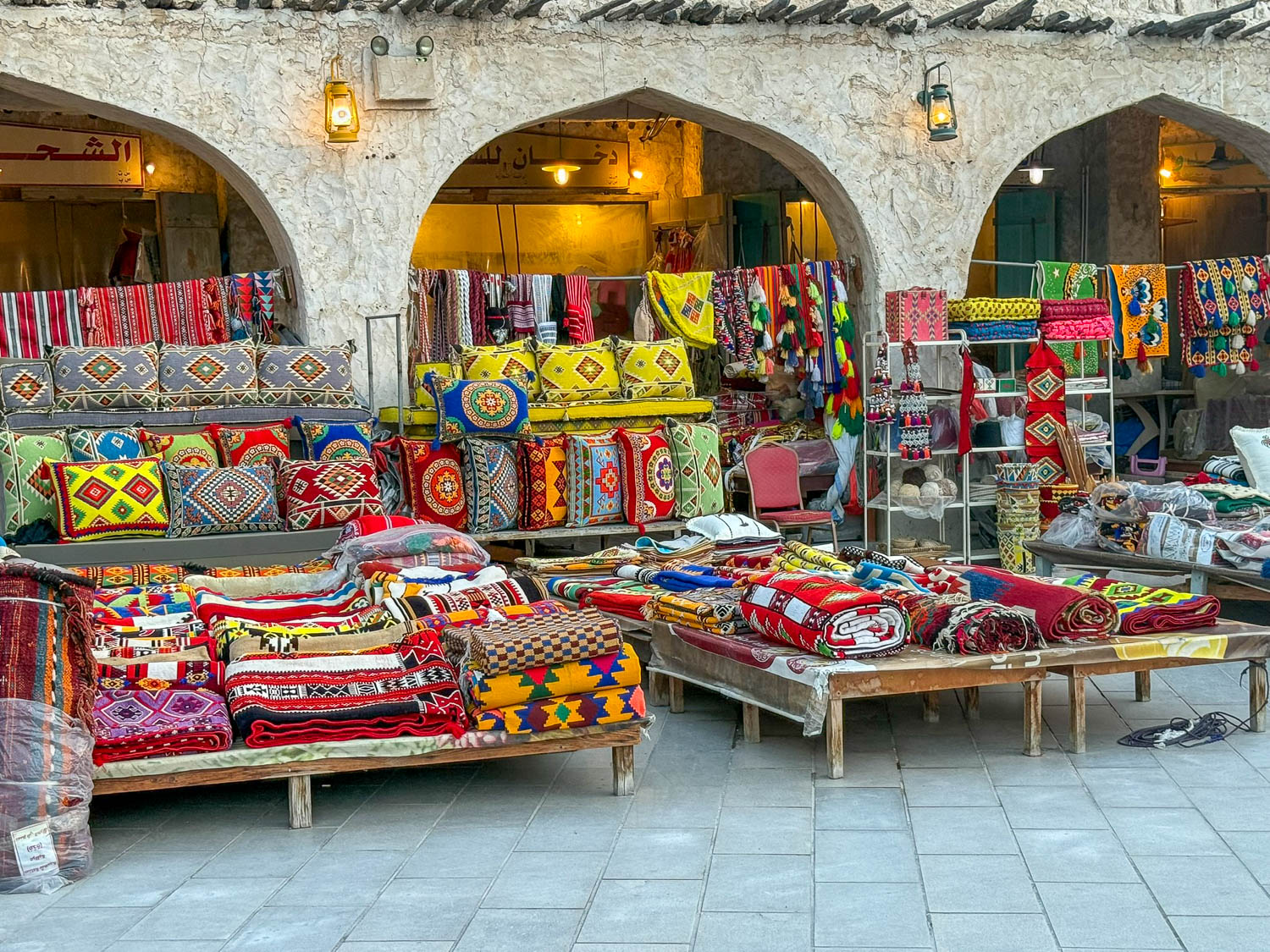 Colorful traditional Qatari textiles for sale at Souq Waqif Doha Qatar