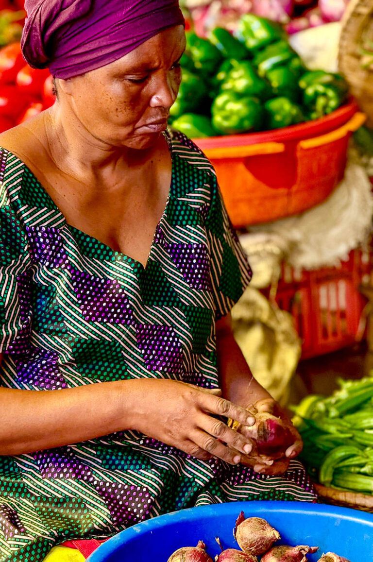 Shoppers buying fresh fruits and vegetables at Kimironko Market in Kigali Rwanda one of the best cultural things to do in Rwanda