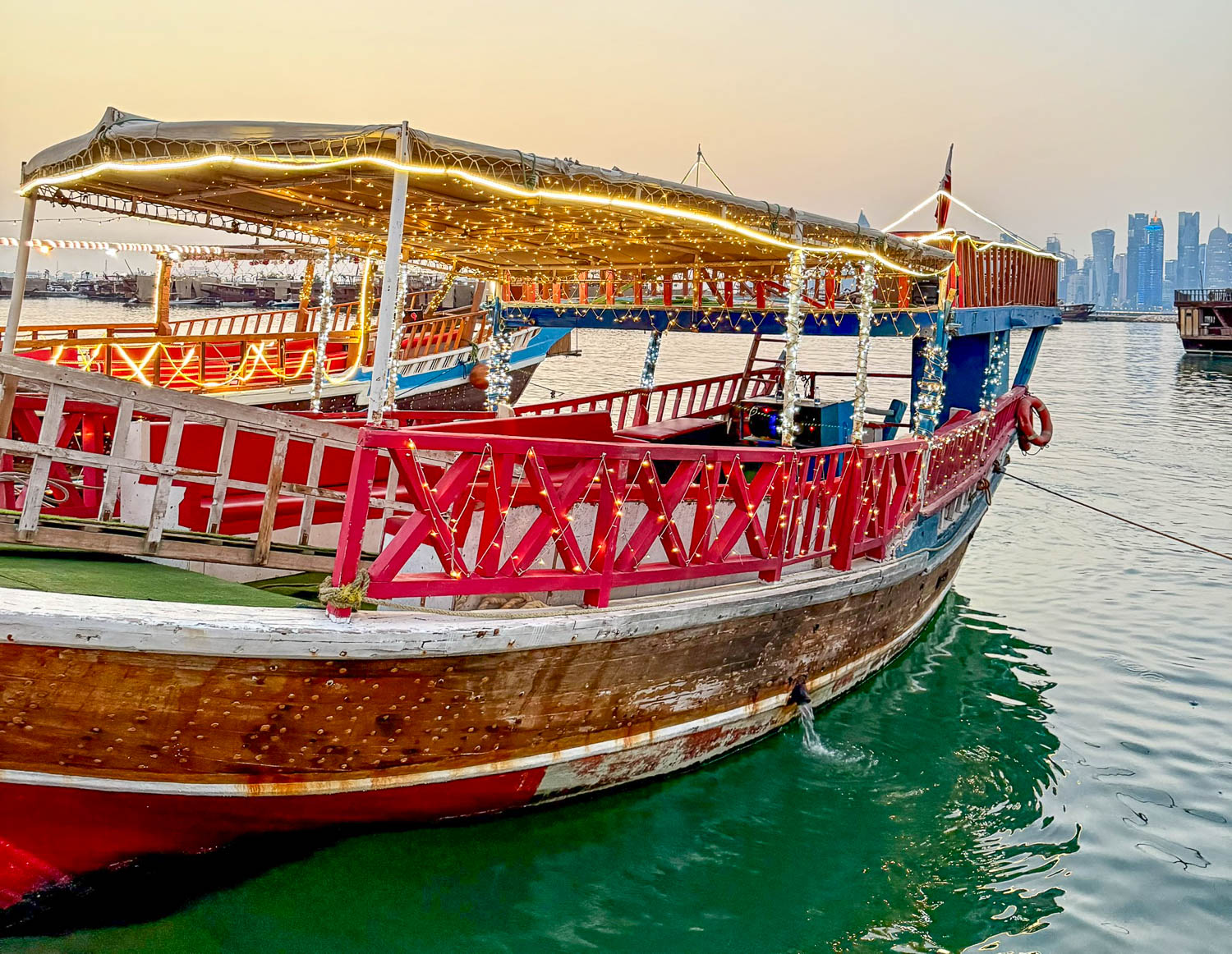 Colorfully decorated traditional dhows during a festival at Dhow Harbour Doha Qatar