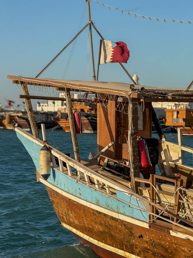 Traditional dhow boats at Dhow Harbour along the Doha Corniche waterfront in Doha Qatar