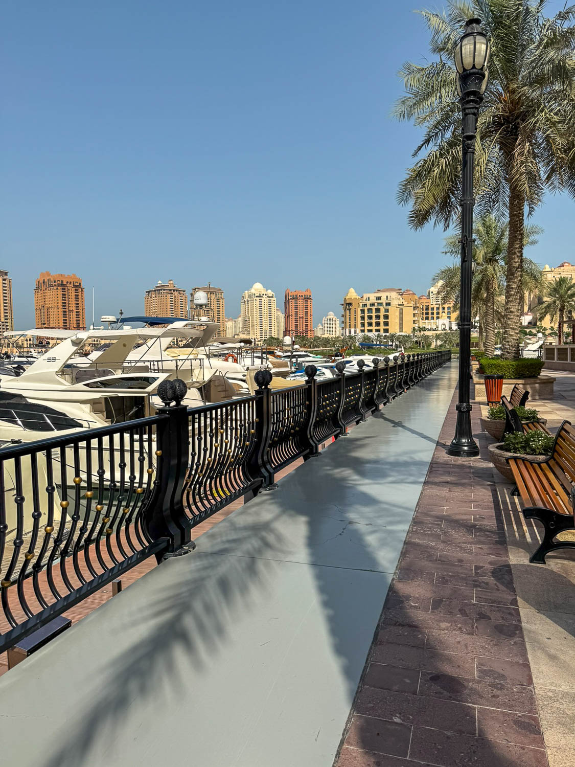 Visitors walking along Porto Arabia waterfront at The Pearl Qatar