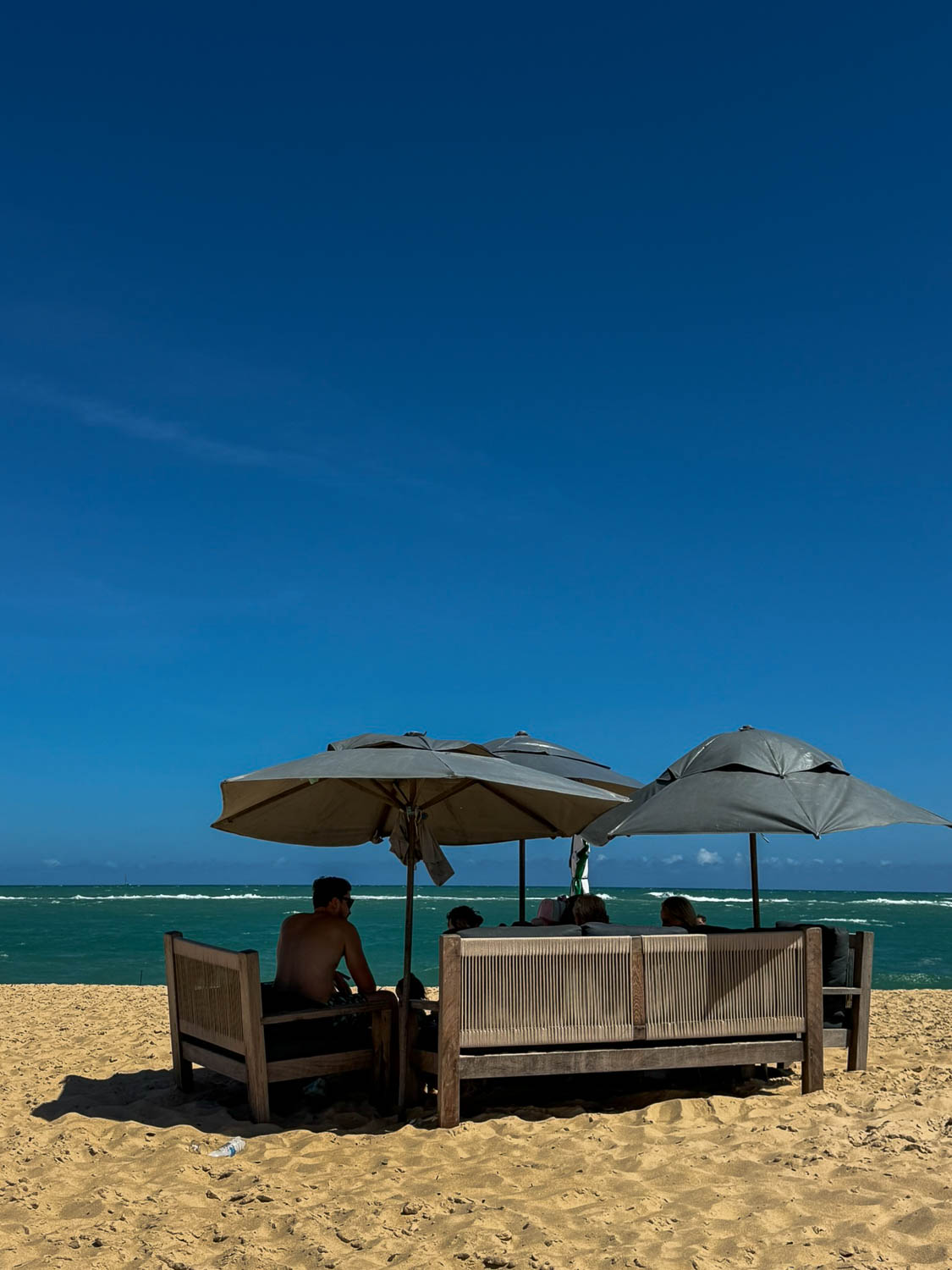 Beach umbrellas and visitors relaxing along the beautiful beaches in Maceio, Brazil
